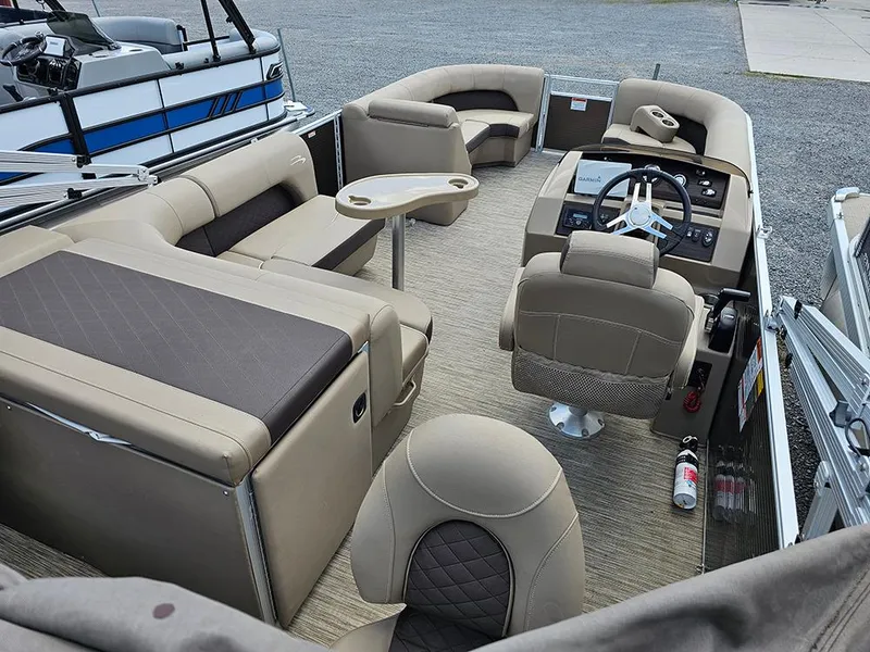 Slide: The Image of 2020 Bennington 22 SSXP pontoon boat interior with beige seating and steering console. - 6