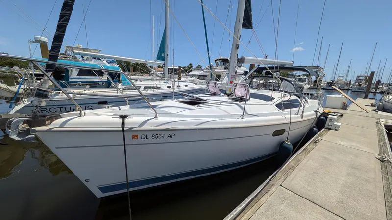 Slide: The Image of 2001 Hunter 380 sailboat docked at marina, clear sky, registration DL 8564 AP. - 0