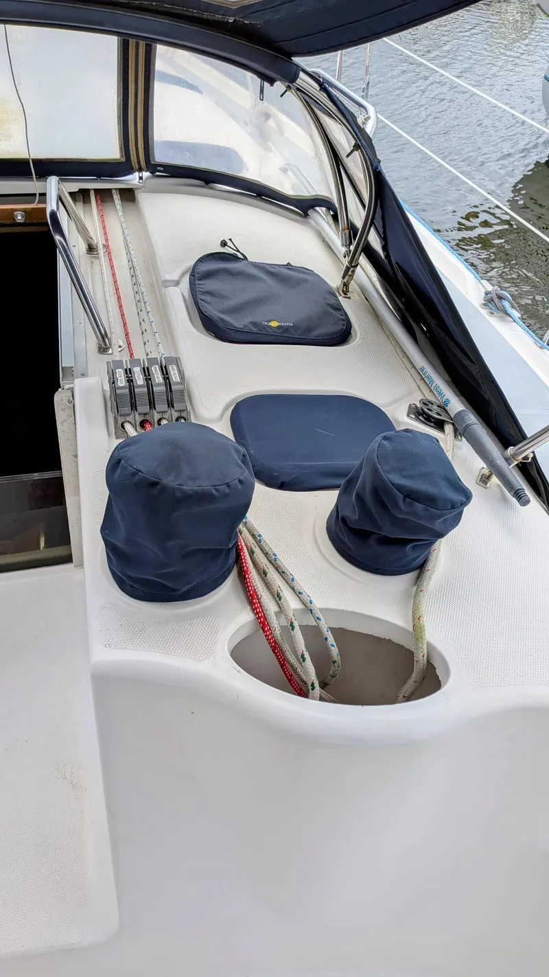 Slide: The Image of Sailboat deck of 2001 Hunter 380 with covered winches and ropes. - 10