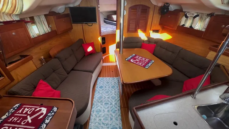 Slide: The Image of Interior of a 2001 Hunter 380 sailboat with cozy seating and nautical decor. - 15