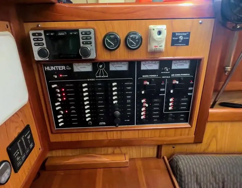 Slide: The Image of Control panel of a 2001 Hunter 380 sailboat with various switches and gauges. - 18