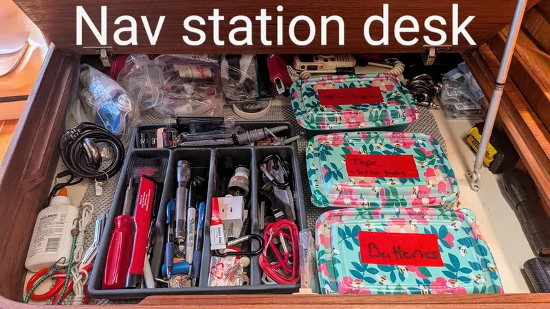 Slide: The Image of Nav station desk with organized tools and supplies on a 2001 Hunter 380 sailboat. - 19