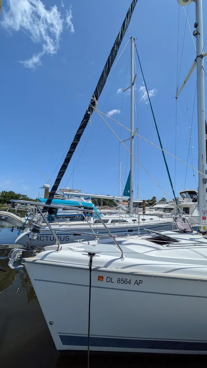 Slide: The Image of Sailboat Hunter 380, 2001 model, docked in a marina under clear blue skies. - 2