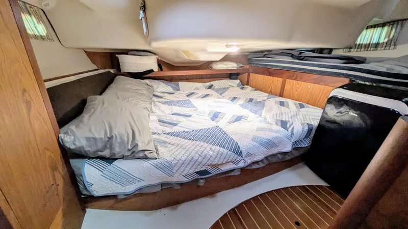 Slide: The Image of Cozy cabin interior of 2001 Hunter 380 sailboat with bed and compact fridge. - 21