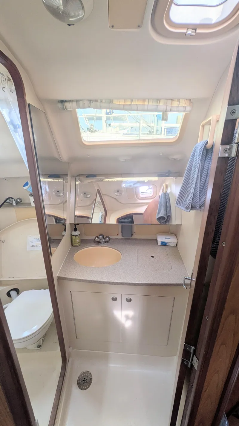 Slide: The Image of 2001 Hunter 380 yacht bathroom with sink, mirror, and skylight. - 24