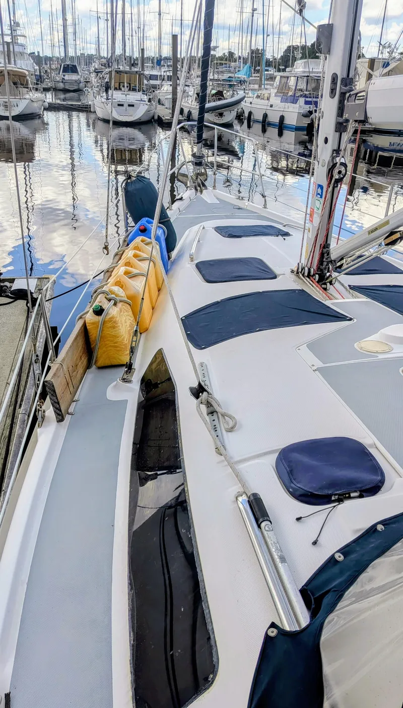 Slide: The Image of 2001 Hunter 380 sailboat docked at marina with other boats in background. - 7