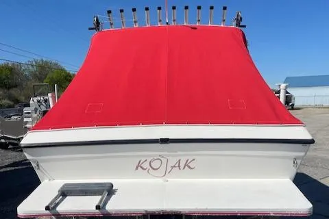 Slide: The Image of 1998 Sport-Craft 232 boat with red cover, docked outdoors. - 10