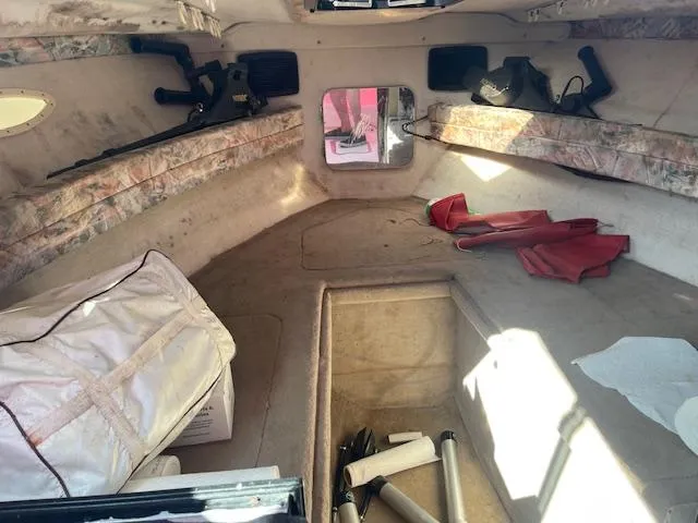 Slide: The Image of Interior of a 1998 Sport-Craft 232 boat cabin with storage and equipment. - 2