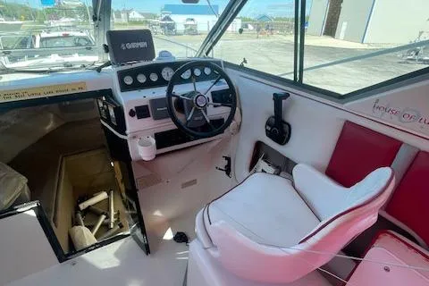 Slide: The Image of 1998 Sport-Craft 232 boat cockpit with steering wheel, controls, and seating. - 4