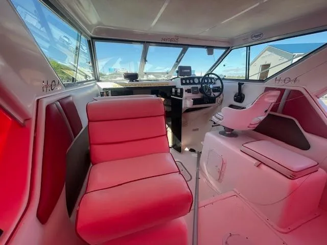 Slide: The Image of Interior of a 1998 Sport-Craft 232 boat with red seating and steering wheel. - 5