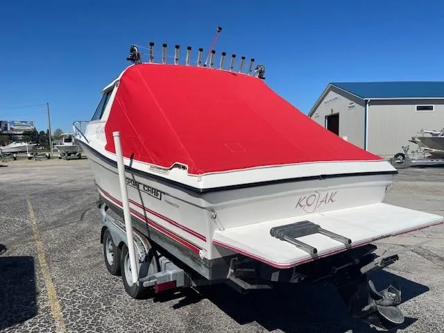 Slide: The Image of 1998 Sport-Craft 232 boat with red cover on trailer, parked outdoors. - 9