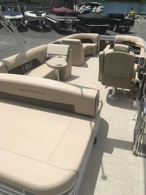 Slide: The Image of 2019 Bennington 23 SSBX pontoon boat with beige seating and spacious deck layout. - 3
