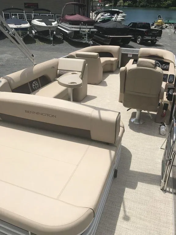 Slide: The Image of 2019 Bennington 23 SSBX pontoon boat with beige seating and spacious deck layout. - 6
