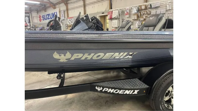 Slide: The Image of 2025 Phoenix 721 ZXL boat in showroom, featuring sleek design and branding. - 4