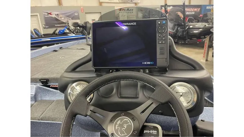 Slide: The Image of 2025 Phoenix 721 ZXL boat dashboard with Lowrance HDS9 display and steering wheel. - 6