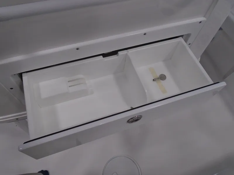 Slide: The Image of Open storage compartment on 2025 Caymas 26 HB boat, showcasing interior design and functionality. - 12