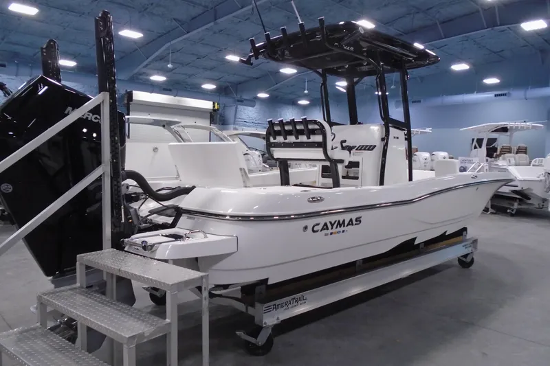 Slide: The Image of 2026 Caymas 26 HB boat displayed indoors, featuring sleek design and modern equipment. - 20