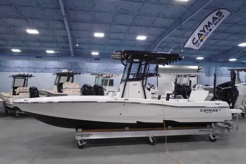 Slide: The Image of 2026 Caymas 26 HB boat displayed indoors, showcasing sleek design and modern features. - 22