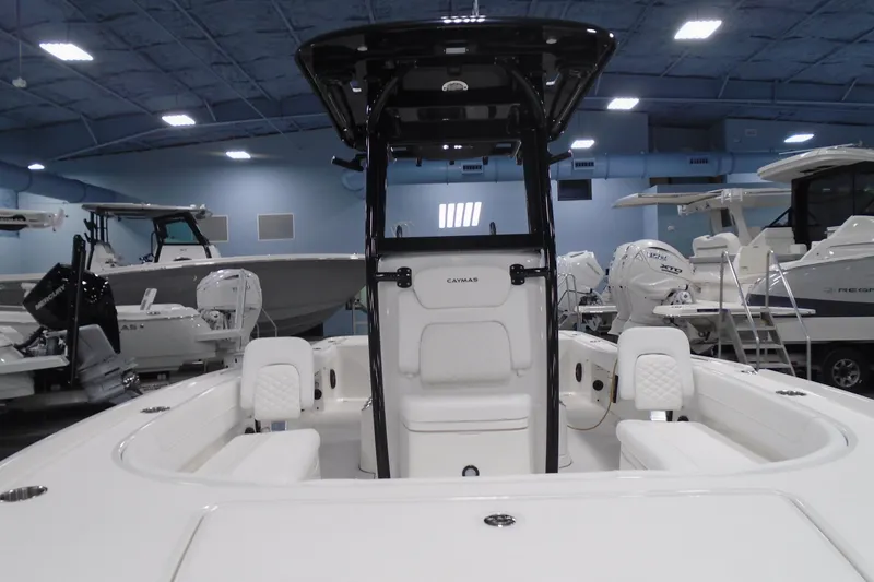 Slide: The Image of 2026 Caymas 26 HB boat interior in showroom, featuring sleek design and modern seating. - 25