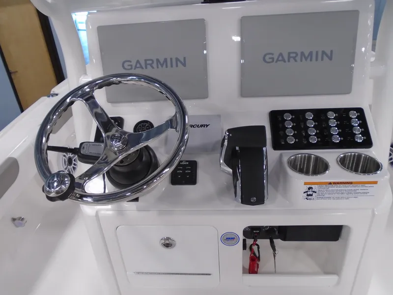 Slide: The Image of 2026 Caymas 26 HB boat on trailer, parked outdoors near industrial buildings. - 3