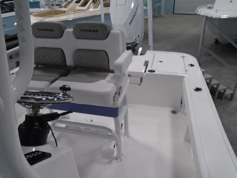 Slide: The Image of 2026 Caymas 26 HB boat with powerful outboard motor, parked on a trailer. - 7