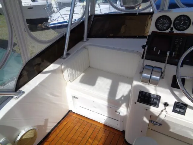 Slide: The Image of 1999 Albemarle 325 Convertible boat cockpit with seating and control panel. - 14