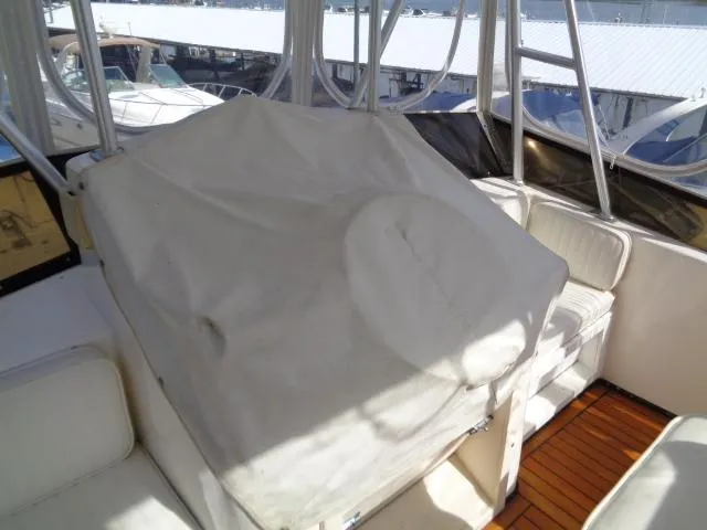 Slide: The Image of 1999 Albemarle 325 Convertible boat interior with covered seating and wooden flooring. - 18