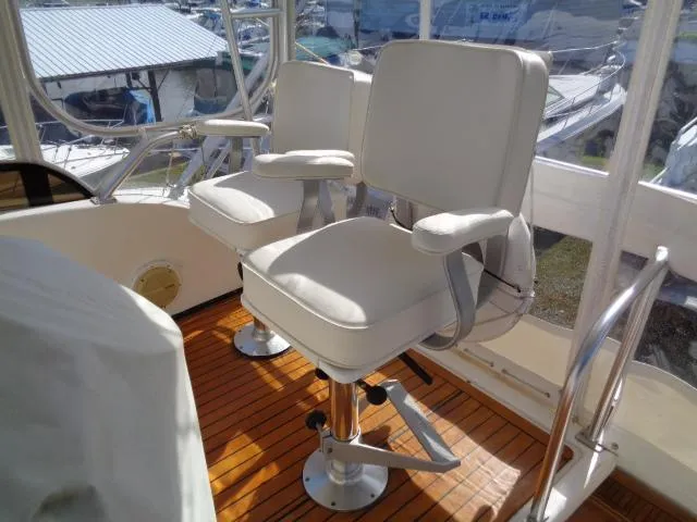 Slide: The Image of Two white captain's chairs on a 1999 Albemarle 325 Convertible boat deck. - 19
