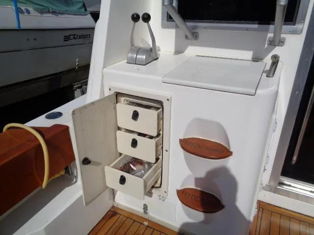 Slide: The Image of 1999 Albemarle 325 Convertible boat interior with storage drawers and control levers. - 23