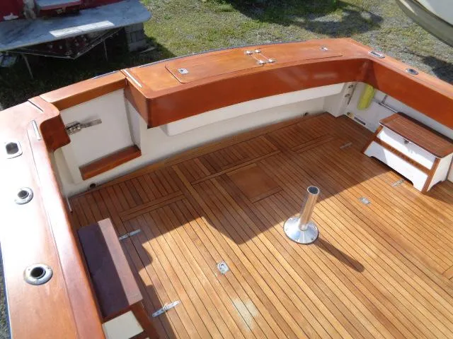 Slide: The Image of 1999 Albemarle 325 Convertible boat deck with wooden flooring and seating. - 26