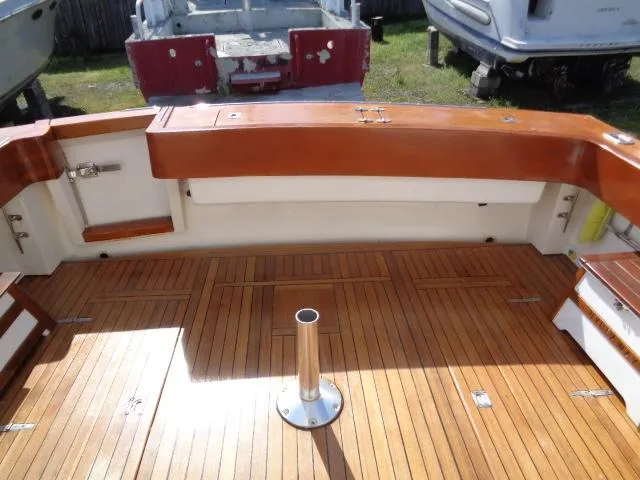 Slide: The Image of 1999 Albemarle 325 Convertible boat deck with wooden flooring and seating area. - 28