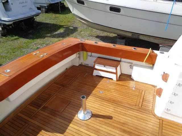 Slide: The Image of 1999 Albemarle 325 Convertible boat deck with wooden flooring and seating area. - 30