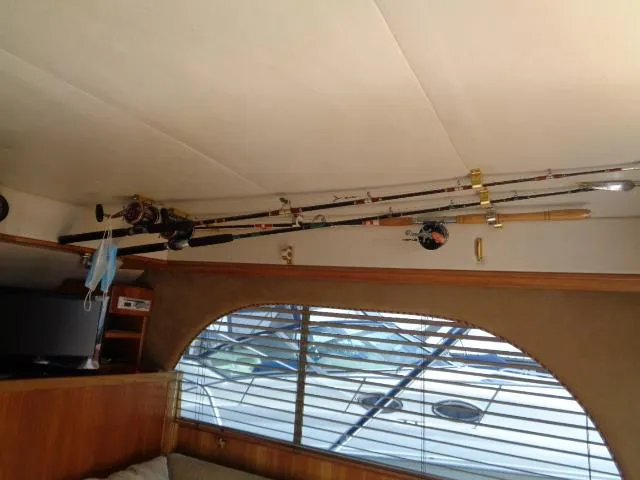 Slide: The Image of Interior of a 1999 Albemarle 325 Convertible boat with fishing rods stored overhead. - 35