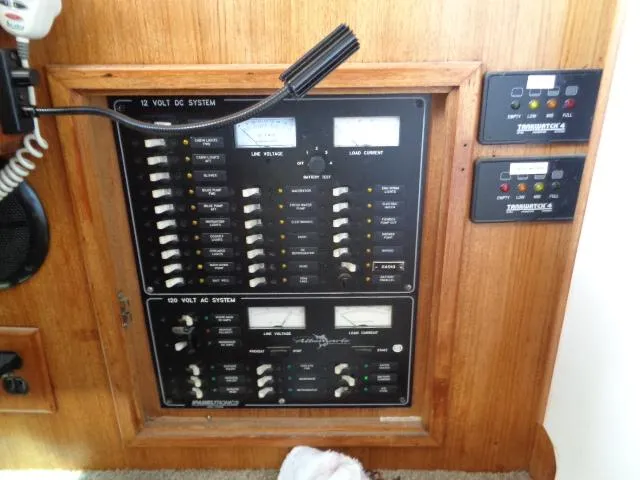 Slide: The Image of Electrical control panel on a 1999 Albemarle 325 Convertible boat, featuring AC and DC systems. - 37