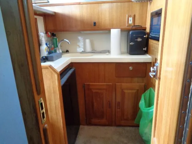 Slide: The Image of 1999 Albemarle 325 Convertible boat kitchen with wooden cabinets and countertop. - 41
