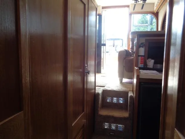 Slide: The Image of Interior view of 1999 Albemarle 325 Convertible boat with wooden cabinetry and carpeted steps. - 45