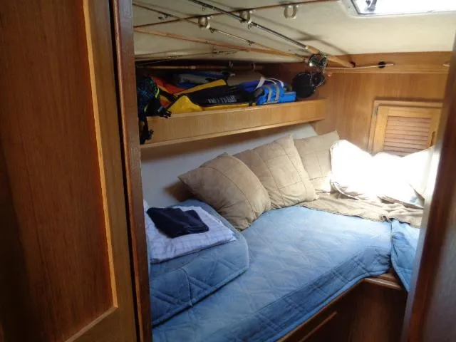 Slide: The Image of Cozy cabin interior of 1999 Albemarle 325 Convertible with blue bedding and wooden accents. - 47