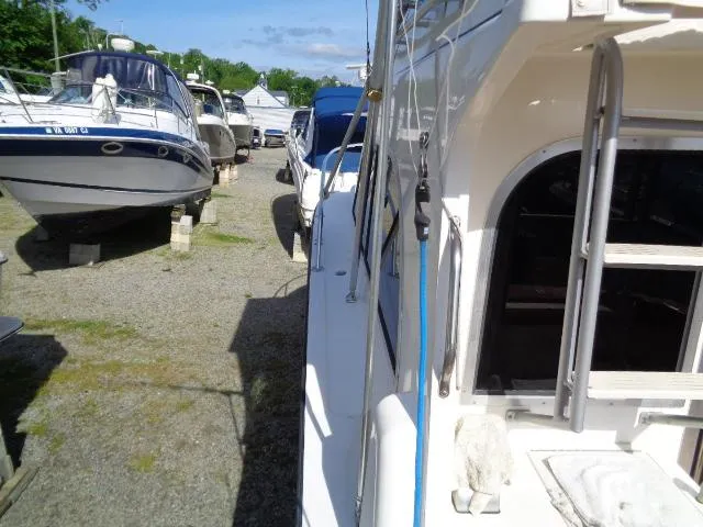 Slide: The Image of 1999 Albemarle 325 Convertible boat in a marina, surrounded by other vessels. - 6