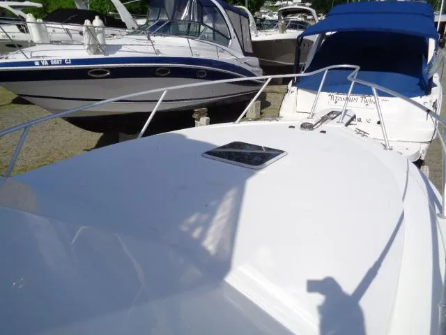 Slide: The Image of 1999 Albemarle 325 Convertible boat docked with other vessels in a marina. - 8