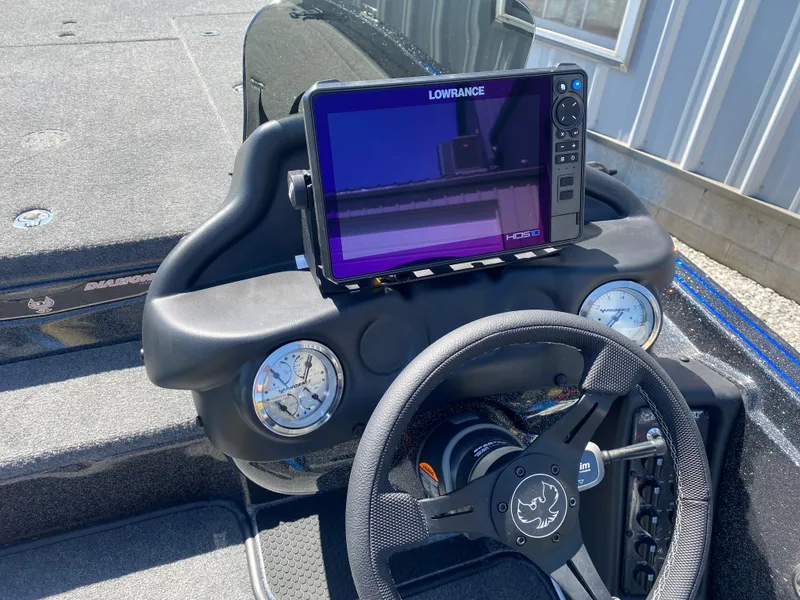 Slide: The Image of 2025 Phoenix 721 ZXL boat dashboard with Lowrance display and steering wheel. - 10