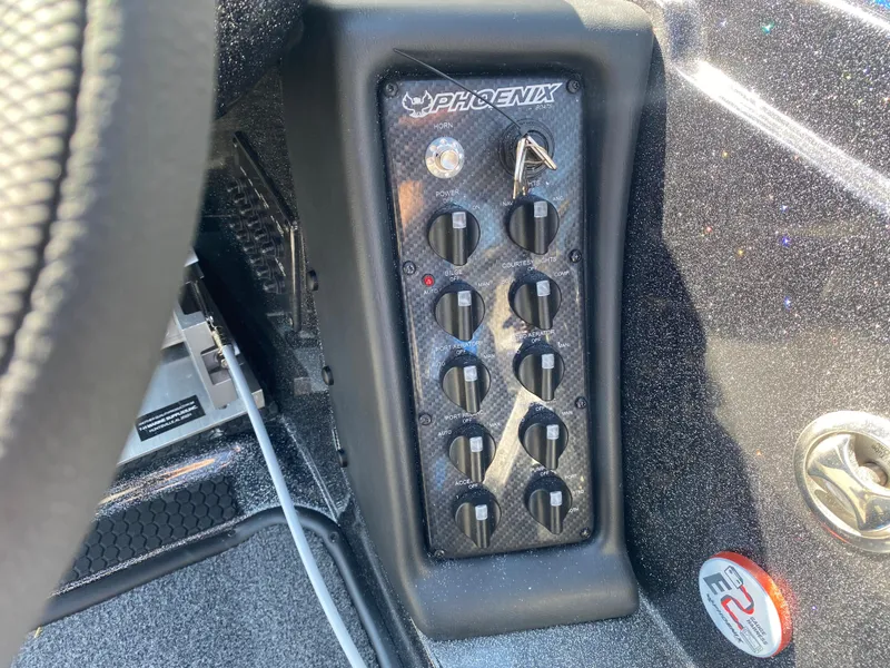 Slide: The Image of Control panel of 2025 Phoenix 721 ZXL boat with multiple switches and sleek design. - 11