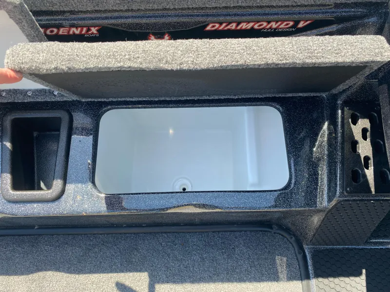 Slide: The Image of 2025 Phoenix 721 ZXL boat storage compartment with open lid, showcasing interior space and design. - 13