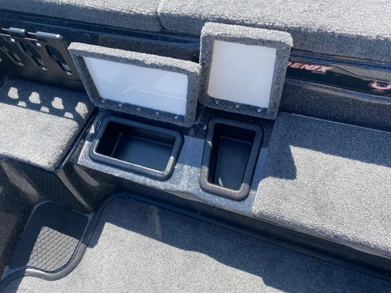 Slide: The Image of 2025 Phoenix 721 ZXL boat dashboard with dual screens and storage compartments. - 14