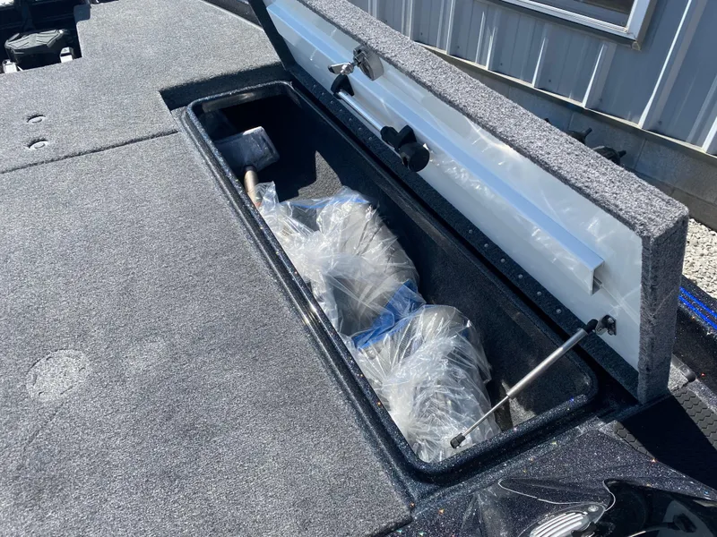 Slide: The Image of 2025 Phoenix 721 ZXL boat storage compartment with open lid, showing wrapped items inside. - 17