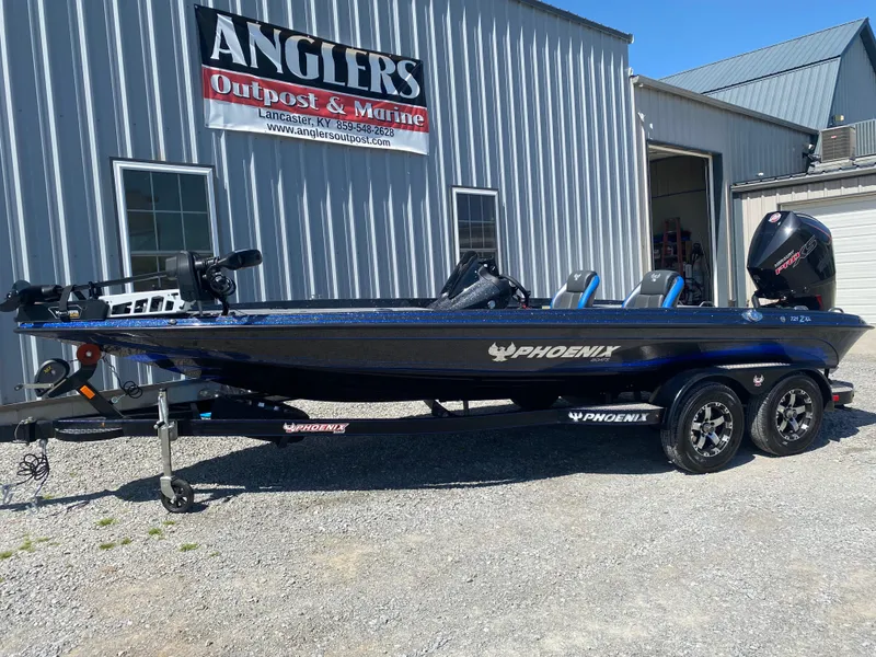 Slide: The Image of 2025 Phoenix 721 ZXL boat parked outside Anglers Outpost & Marine. - 2