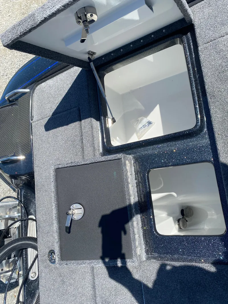 Slide: The Image of Open storage compartments on a 2025 Phoenix 721 ZXL boat. - 26