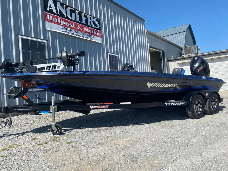 Slide: The Image of 2025 Phoenix 721 ZXL boat on trailer outside Angler's Outpost & Marine. - 3