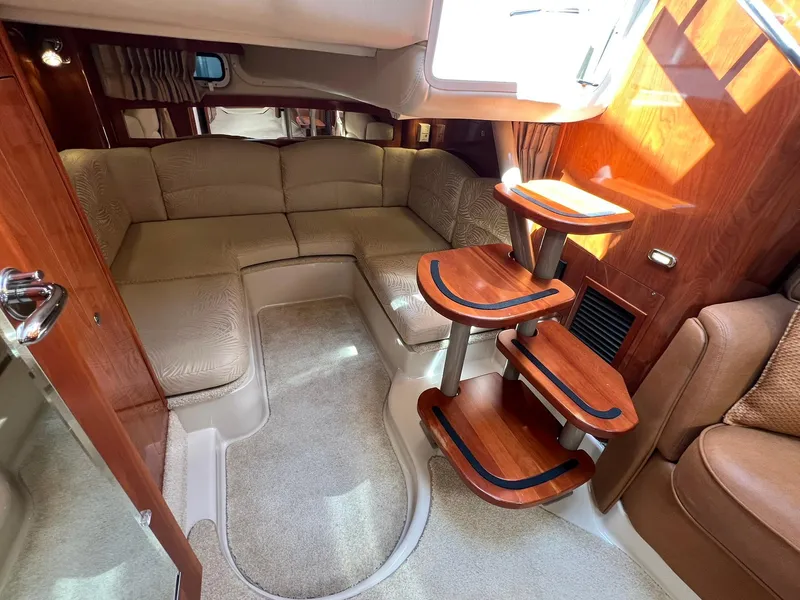 Slide: The Image of Interior of 2006 Four Winns 348 Vista yacht with plush seating and wooden accents. - 11