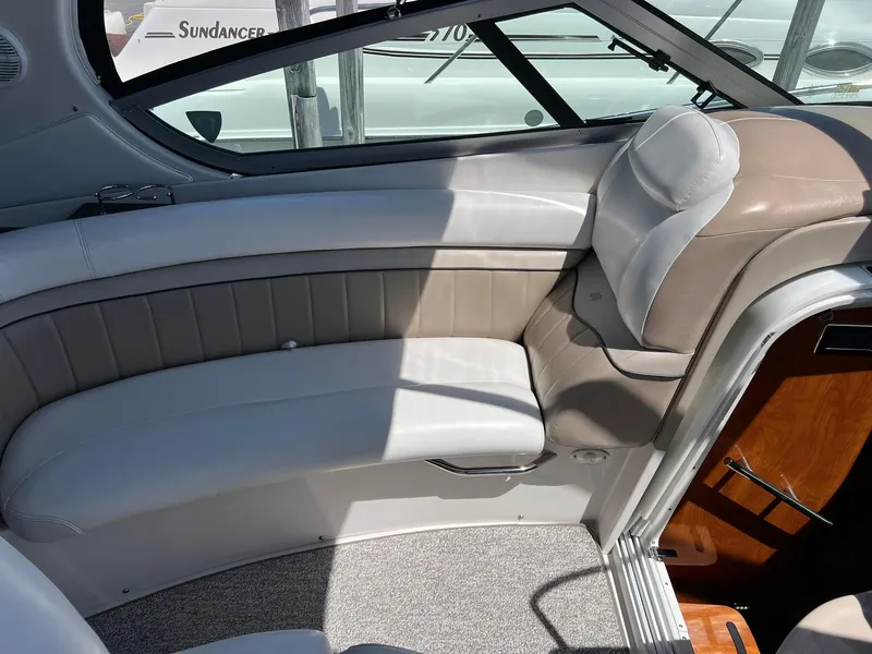 Slide: The Image of Interior seating of 2006 Four Winns 348 Vista boat, featuring beige and white upholstery. - 14