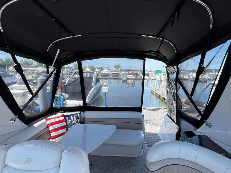 Slide: The Image of 2006 Four Winns 348 Vista boat interior with seating and marina view. - 17